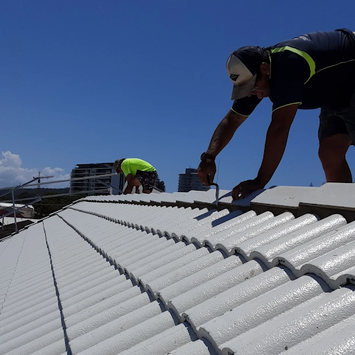 Professional roofer repairing a roof in Brisbane using safety gear and tools.