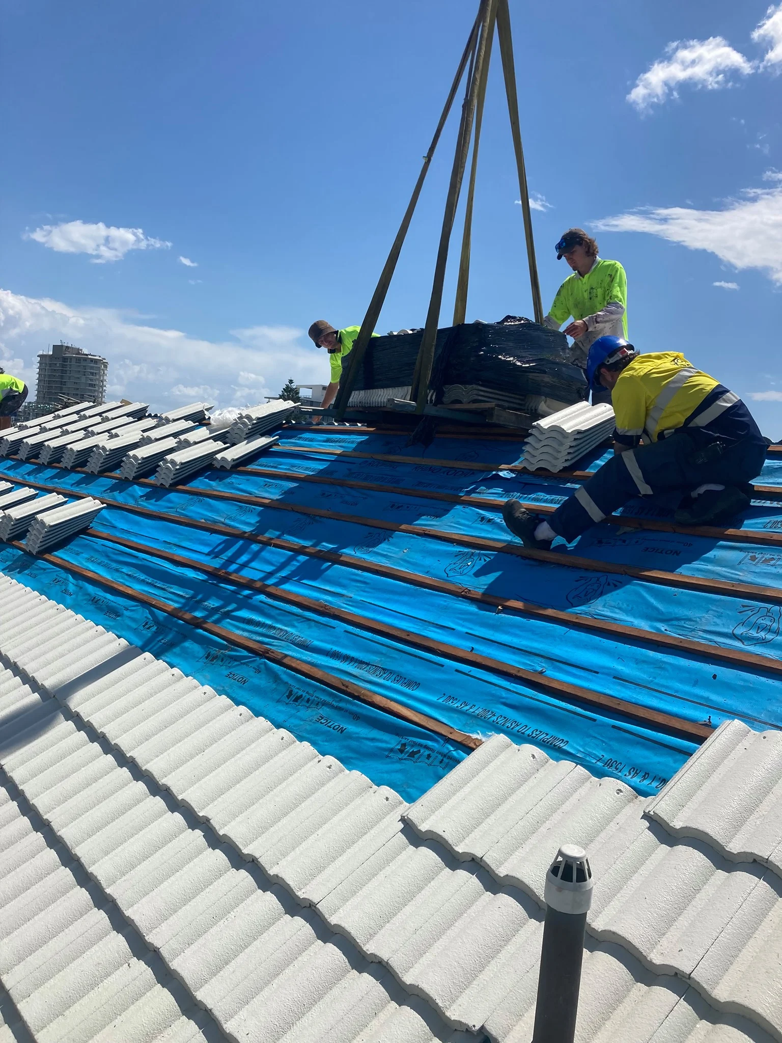 Close-up of a tiled roof underlayment installation on a Brisbane home, showing protective membrane beneath the roof tiles.