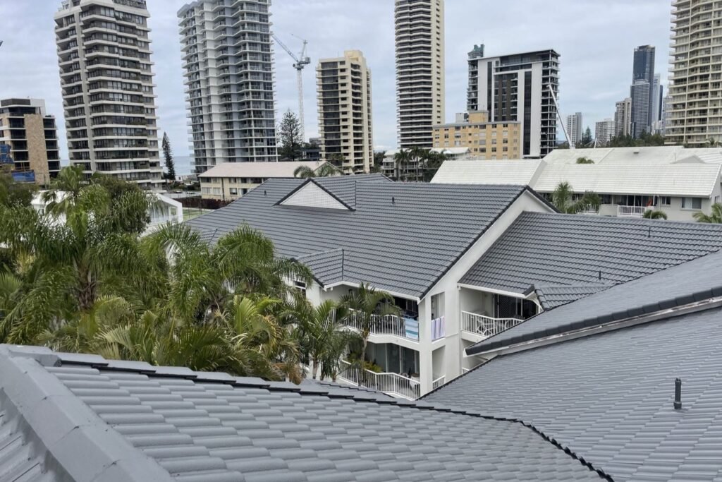 Charcoal tiled roofs on a Gold Coast townhouse complex with Surfers Paradise high rises behind