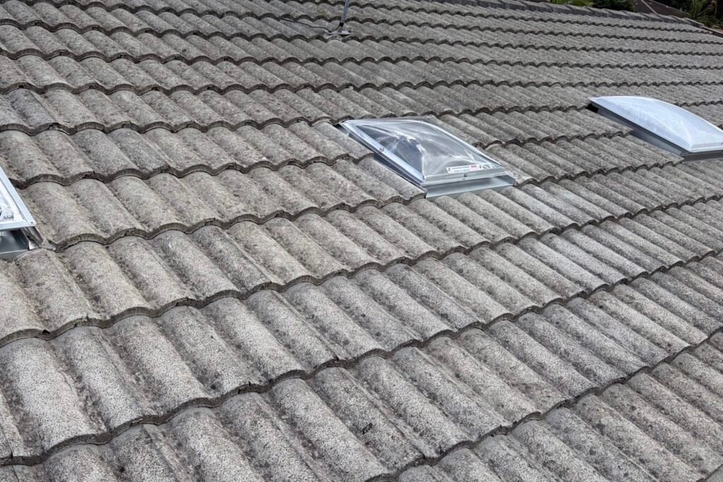 Three skylights installed into a weathered concrete tiled roof in Brisbane